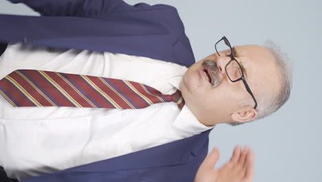 Vertical-video-of-Old-businessman-with-neck-pain.